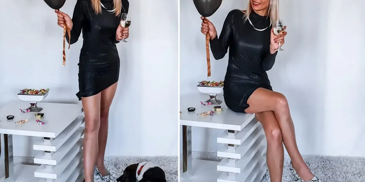Elegancka czarna sukienka, idealna na 18. Urodziny. W dłoni czarny balon i kieliszek szampana. Na podłodze piesek.