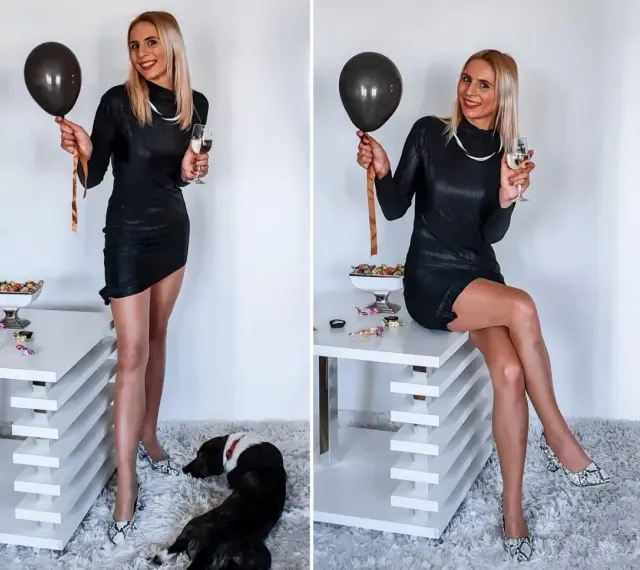 Elegancka czarna sukienka, idealna na 18. Urodziny. W dłoni czarny balon i kieliszek szampana. Na podłodze piesek.